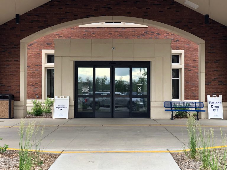 Automatic sliding glass doors at a brick building entrance