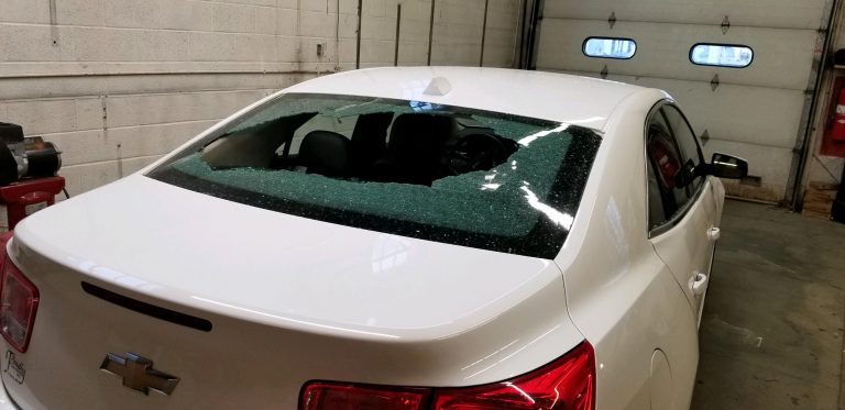 Car with broken rear window before replacement