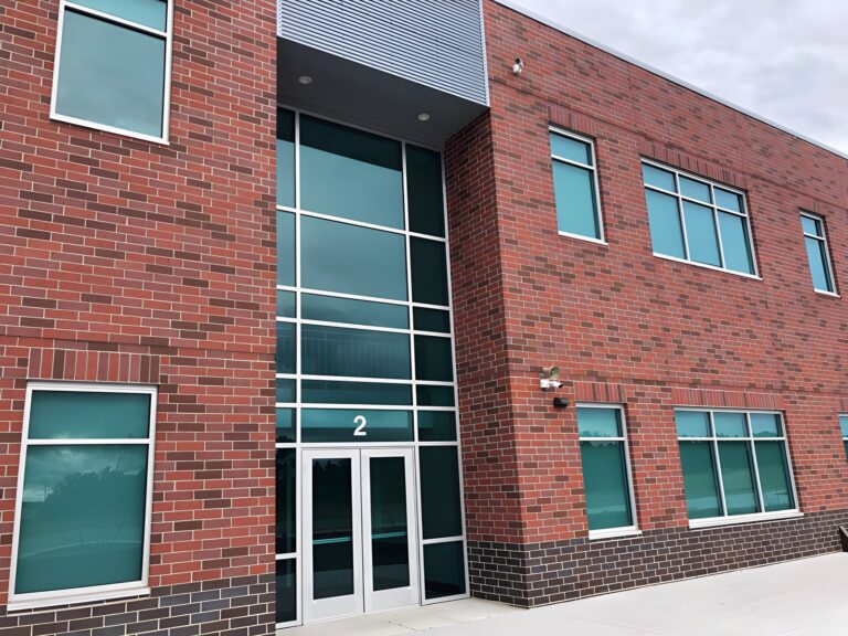Brick building with curtain wall entrance and windows