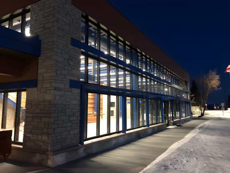 Two-story curtain wall facade at dusk
