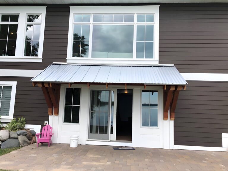 Home exterior with large residential windows and patio door