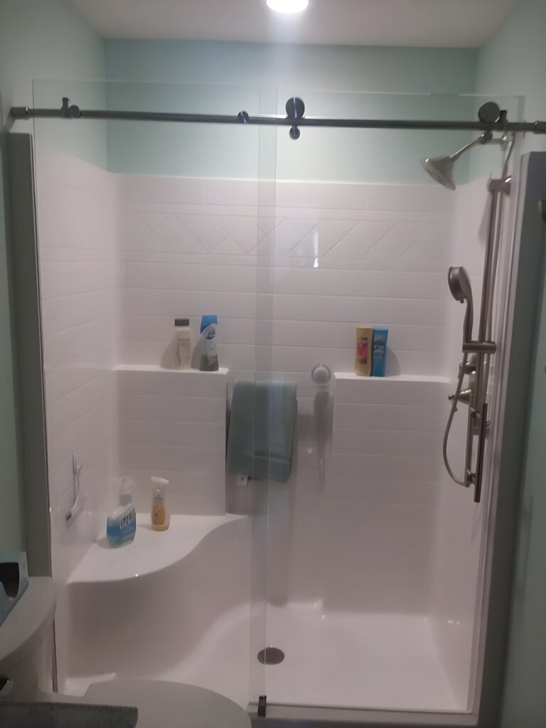 Sliding glass shower door with black hardware